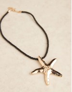 necklace with cord and starfish charm in gold tone