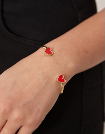 cuff bracelet with enamel heart detail in gold tone